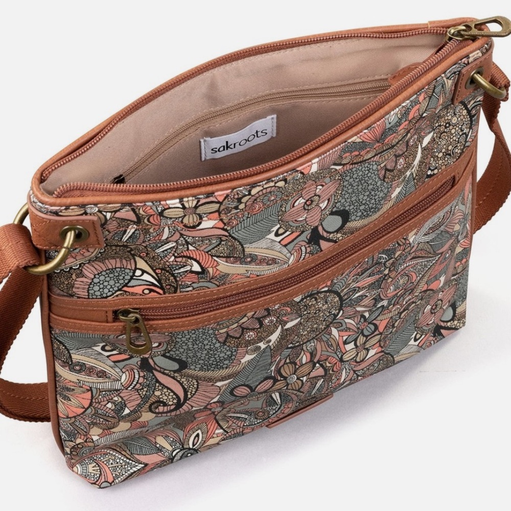 Sakroots Artist Circle Flat Crossbody bag in the Sienna Spirit Desert pattern.